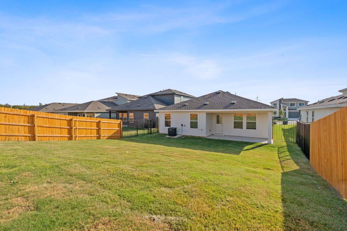 9701 Oxbow Strap Drive Austin, TX 78724 - Photo 33 of 34 Rear view of property featuring a patio area and a fenced backyard