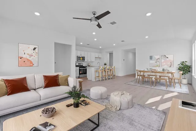 a living room with furniture and kitchen view
