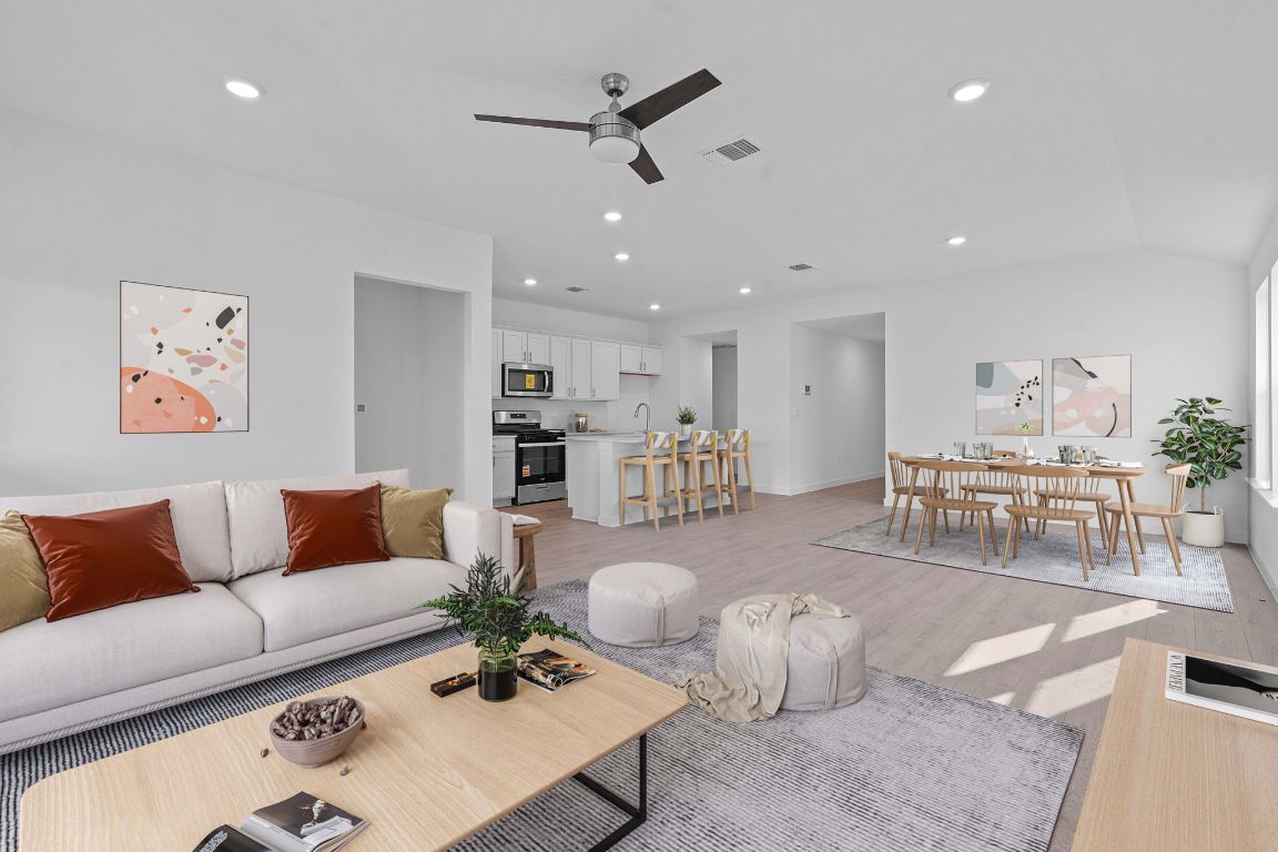 9701 Oxbow Strap Drive Austin, TX 78724 - Photo 4 of 34 Living room with recessed lighting, a ceiling fan, light wood-style floors, and lofted ceiling