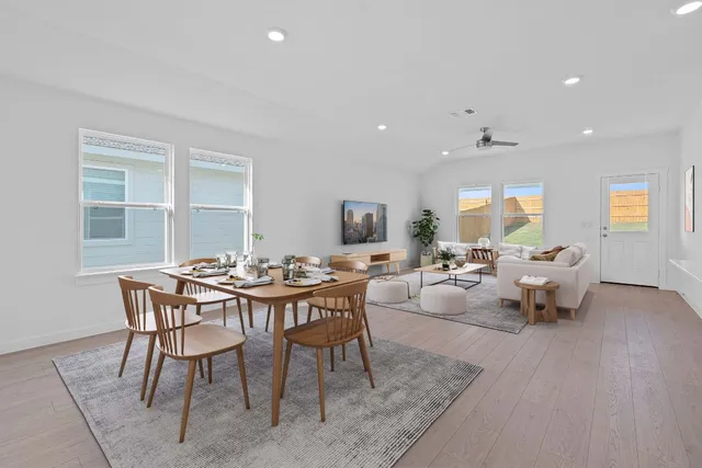 a view of a dining room with furniture and wooden floor