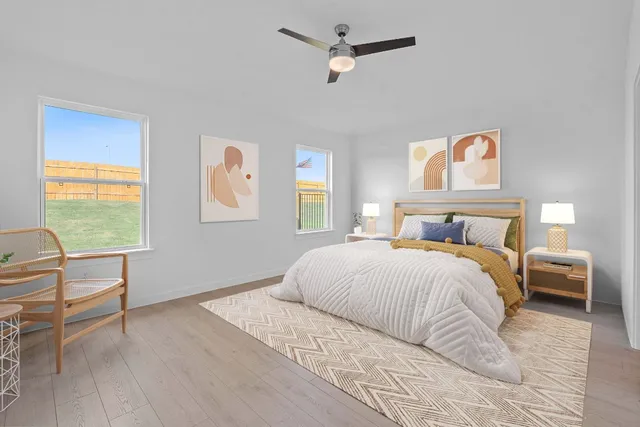 a bedroom with a bed and a chair