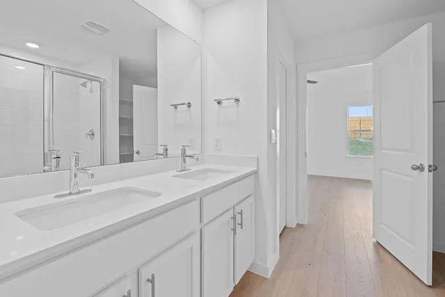 a bathroom with a sink double vanity and a mirror