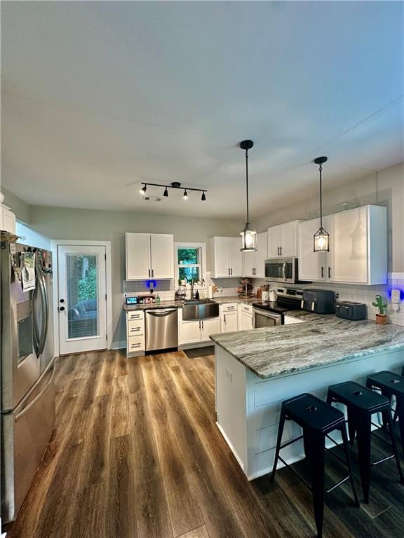 815 Poplar Street Monticello, GA 31064 - Photo 13 of 33 a kitchen view with stainless steel appliances granite countertop a stove and a sink
