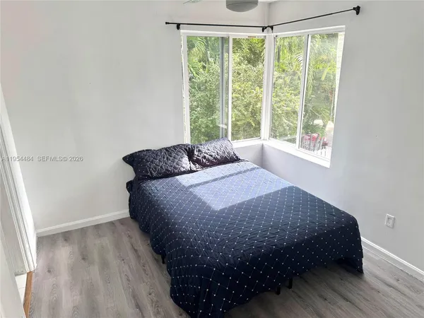 a bedroom with bed and window