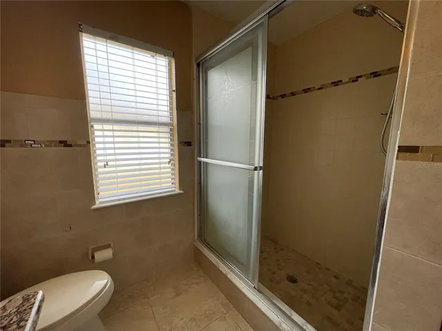 a bathroom with a shower and a toilet