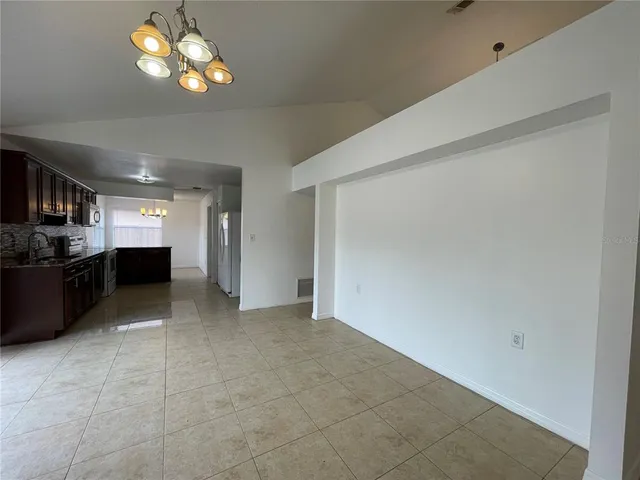 a large kitchen with a large counter top stainless steel appliances and cabinets