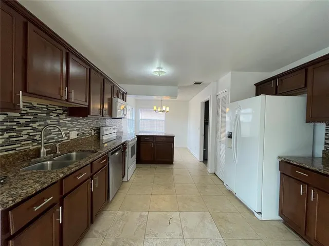 a white refrigerator freezer sitting inside of a kitchen