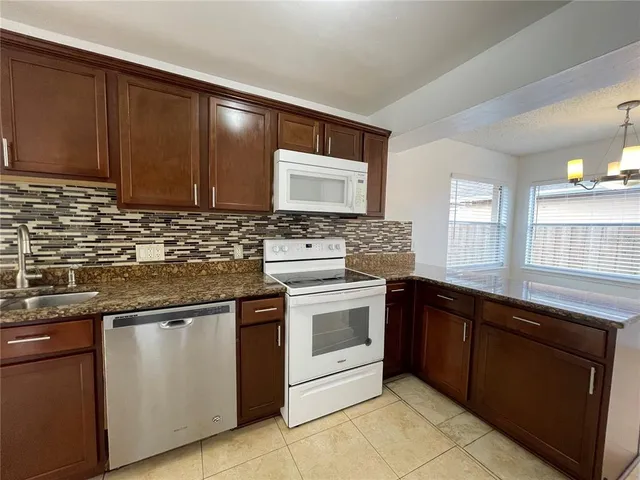 a view of a kitchen with a dishwasher and a window