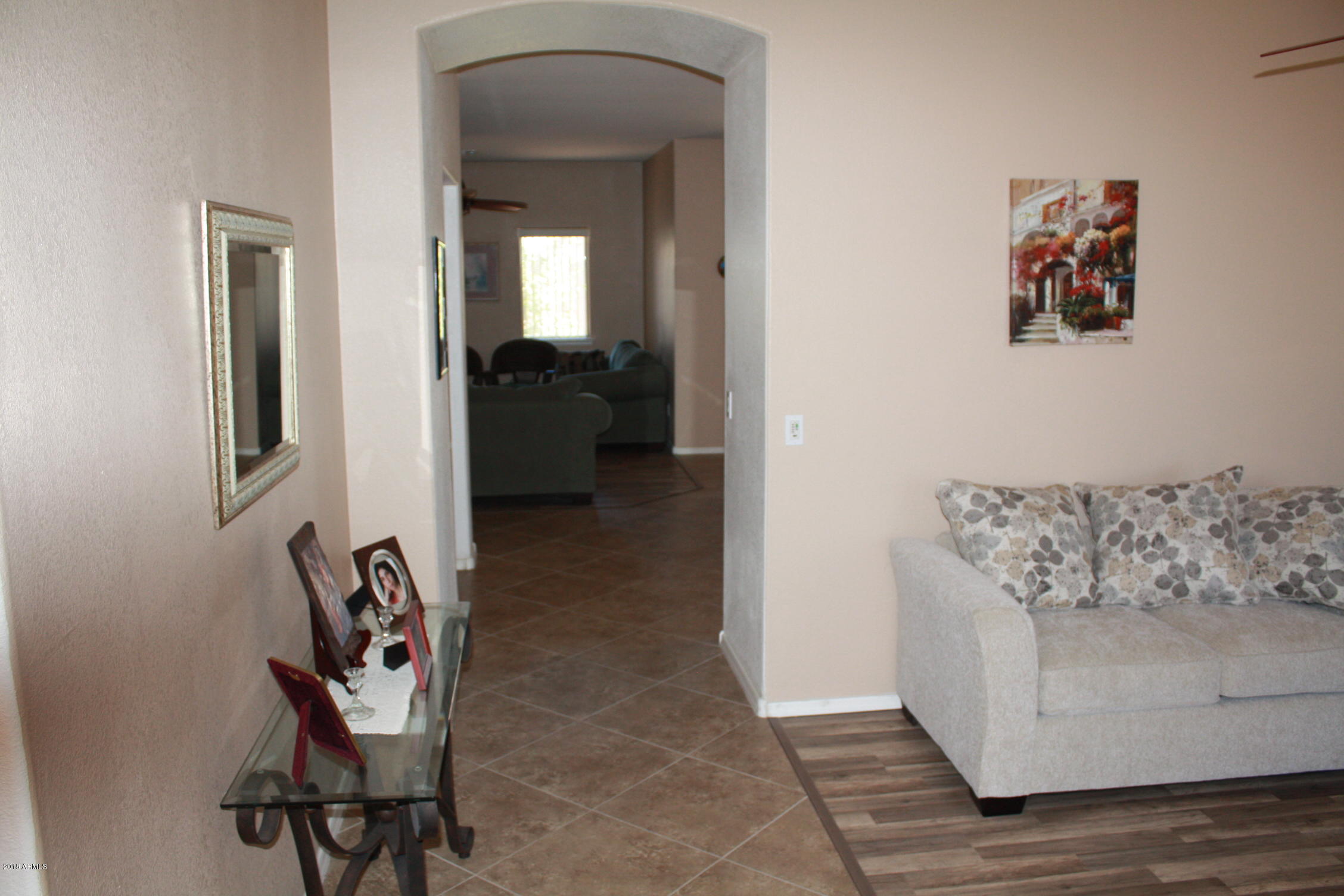 11816 West Windsor Avenue Avondale, AZ 85392 - Photo 12 of 19 a living room with furniture and a painting on the wall