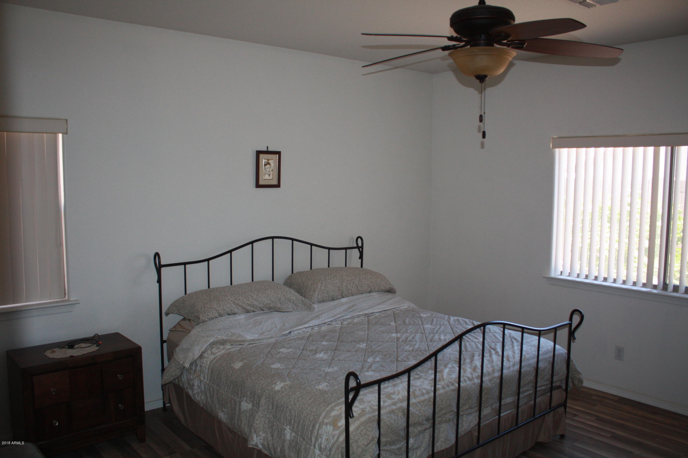 11816 West Windsor Avenue Avondale, AZ 85392 - Photo 13 of 19 a bedroom with a bed and a window