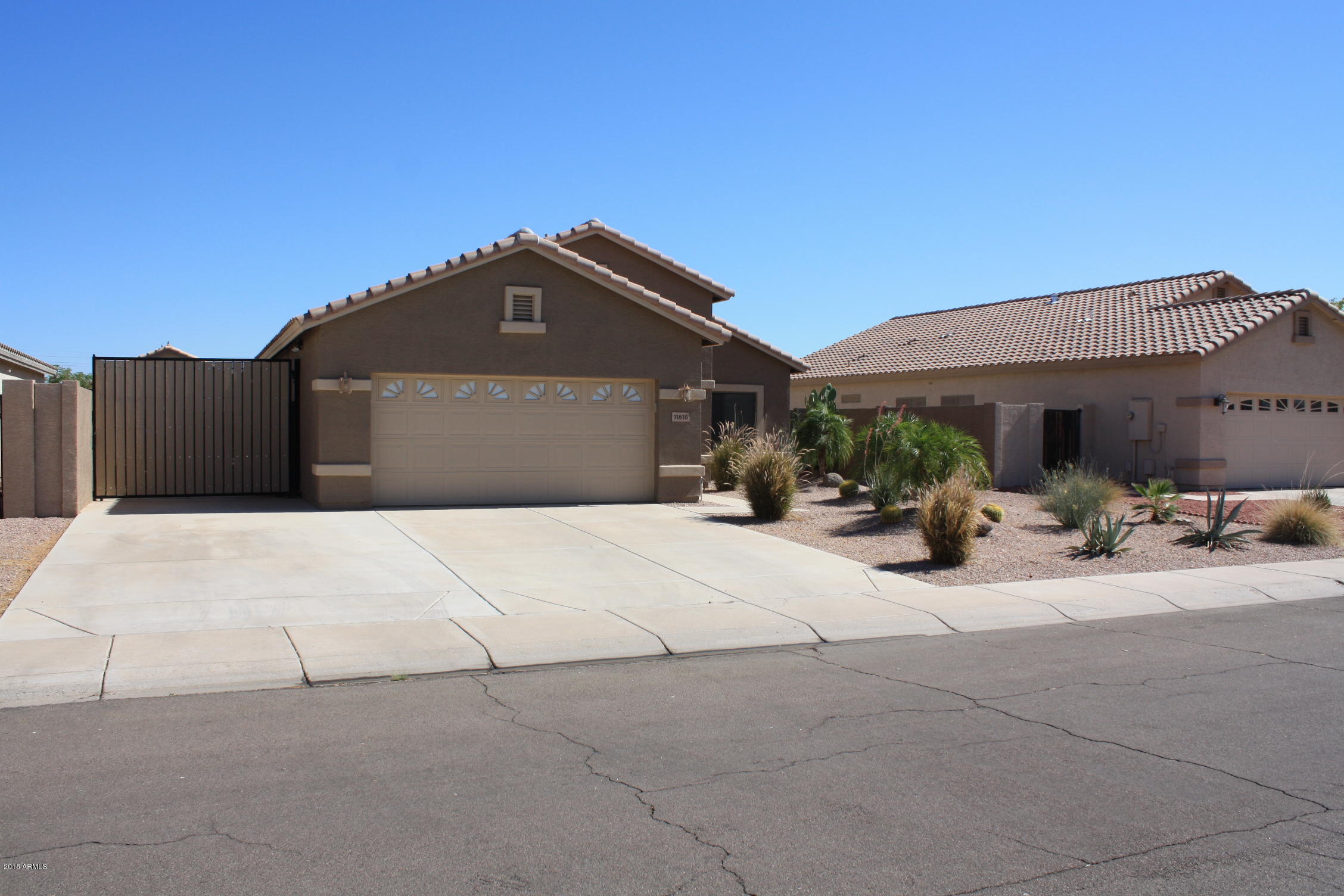 11816 West Windsor Avenue Avondale, AZ 85392 - Photo 2 of 19 a front view of a house with a garden and pathway