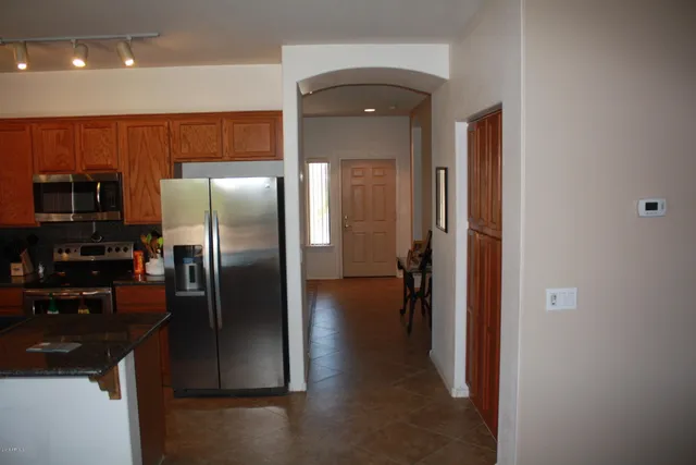 a kitchen with a refrigerator and a sink