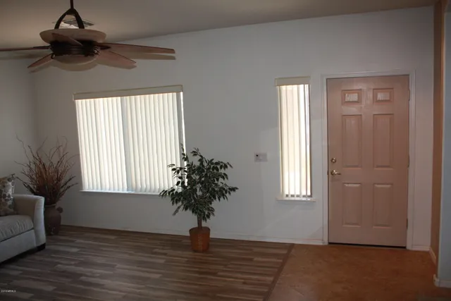 a view of empty room with window and cabinet