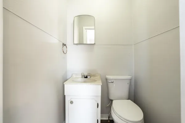 a bathroom with a toilet sink and vanity
