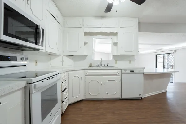 a kitchen with stainless steel appliances granite countertop a sink and a stove top oven