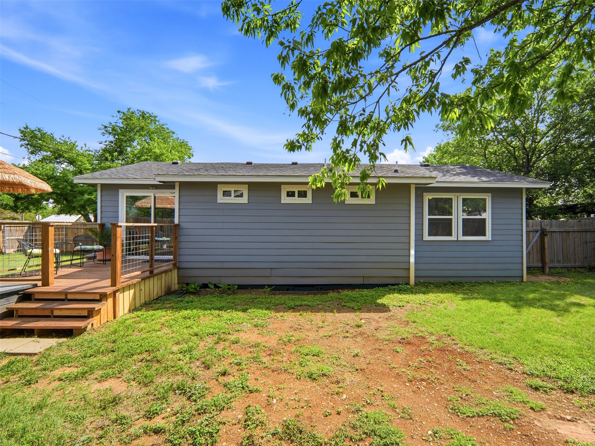 700 9th Street Blanco, TX 78606 - Photo 26 of 33 a view of a house with a small yard and a large tree