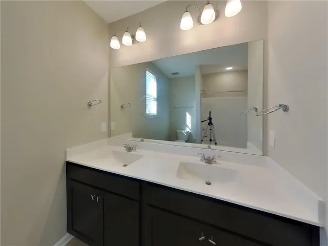a bathroom with a toilet and shower