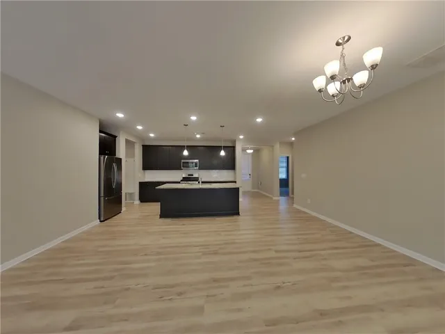a view of kitchen and kitchen with wooden floor