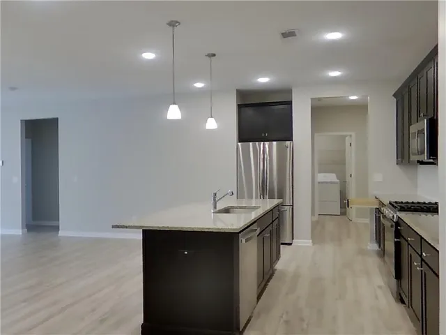 a spacious bathroom with a sink and a mirror