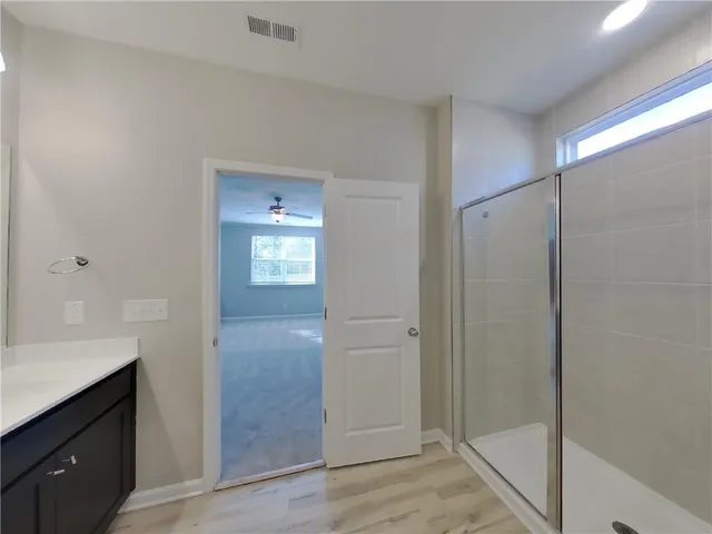 a bathroom with a shower sink and mirror