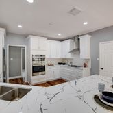 a kitchen with a sink stove and wooden cabinets