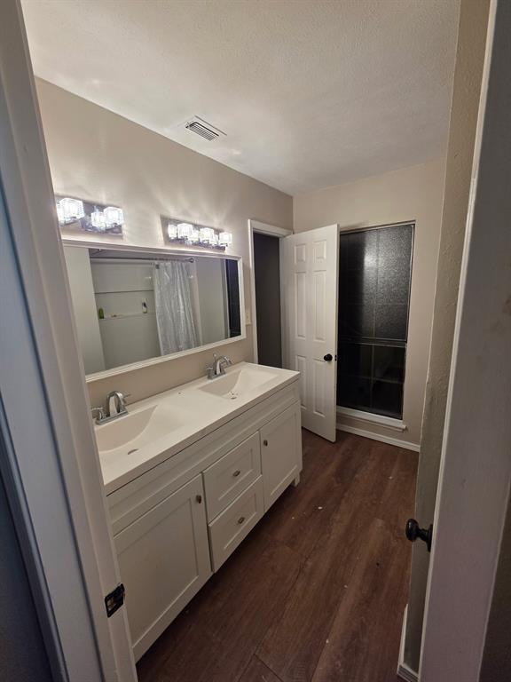 Undisclosed Address Dallas, TX 75238 - Photo 12 of 13 a bathroom with a double vanity sink and mirror