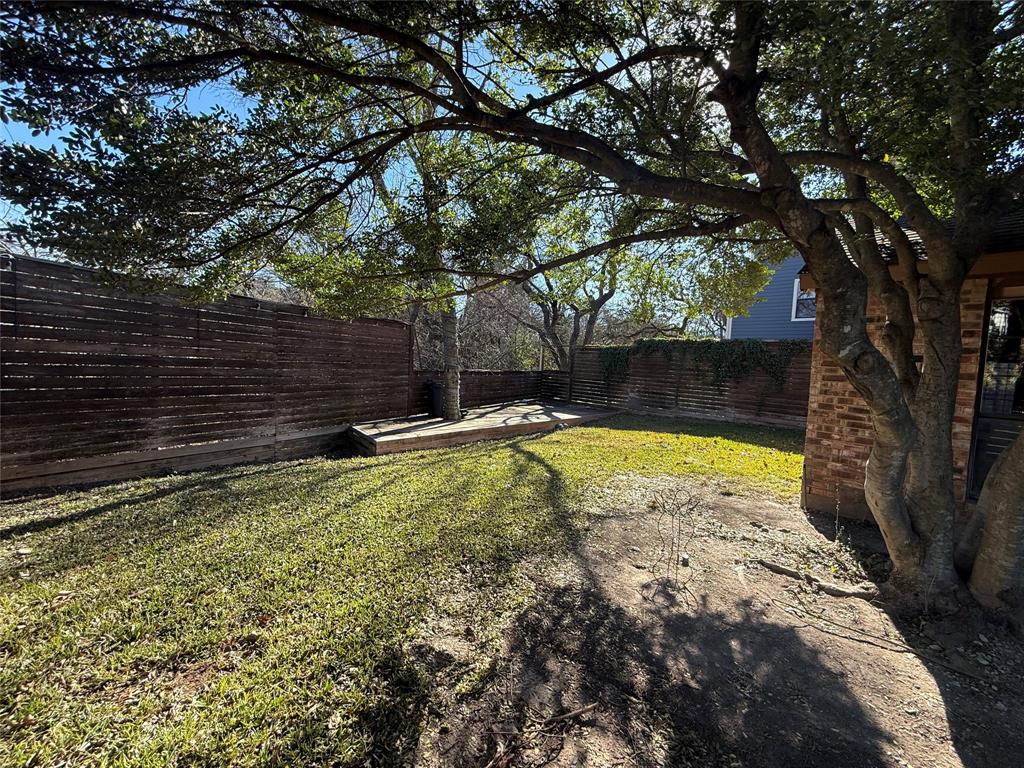 Undisclosed Address Dallas, TX 75238 - Photo 3 of 13 a view of a backyard with a tree