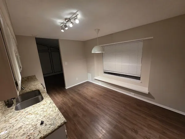 a very nice looking room with wooden floor and a ceiling fan