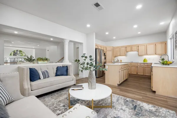 a living room with furniture kitchen view and a dining table