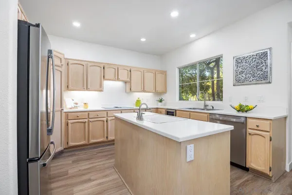 a kitchen with a sink stove and refrigerator