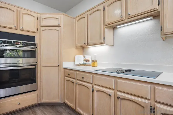 a kitchen with granite countertop white cabinets stainless steel appliances and sink