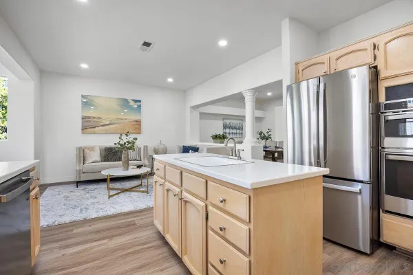a kitchen with stainless steel appliances a sink stove and refrigerator