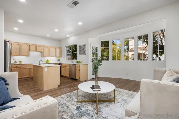 a living room with furniture and kitchen view