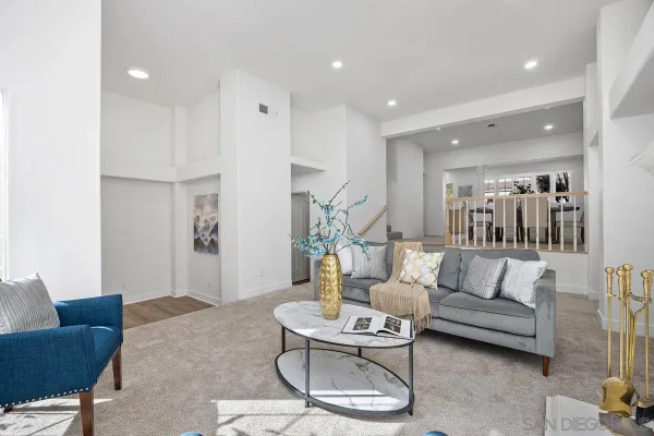 a living room with furniture and kitchen view