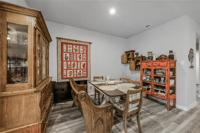 a dining room with furniture and wooden floor