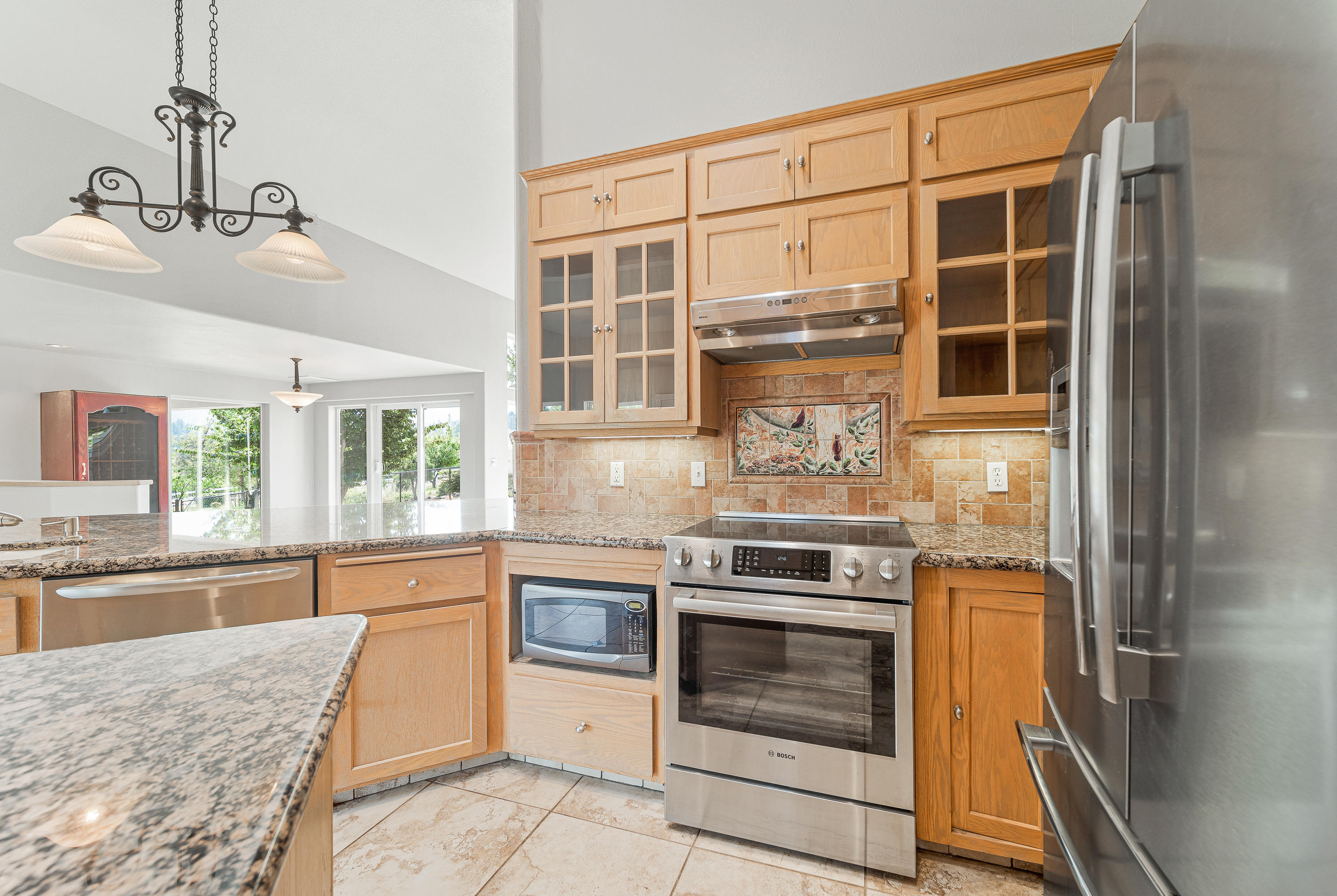 925 Anderson Creek Road Talent, OR 97540 - Photo 9 of 52 a kitchen with stainless steel appliances granite countertop a stove and a sink