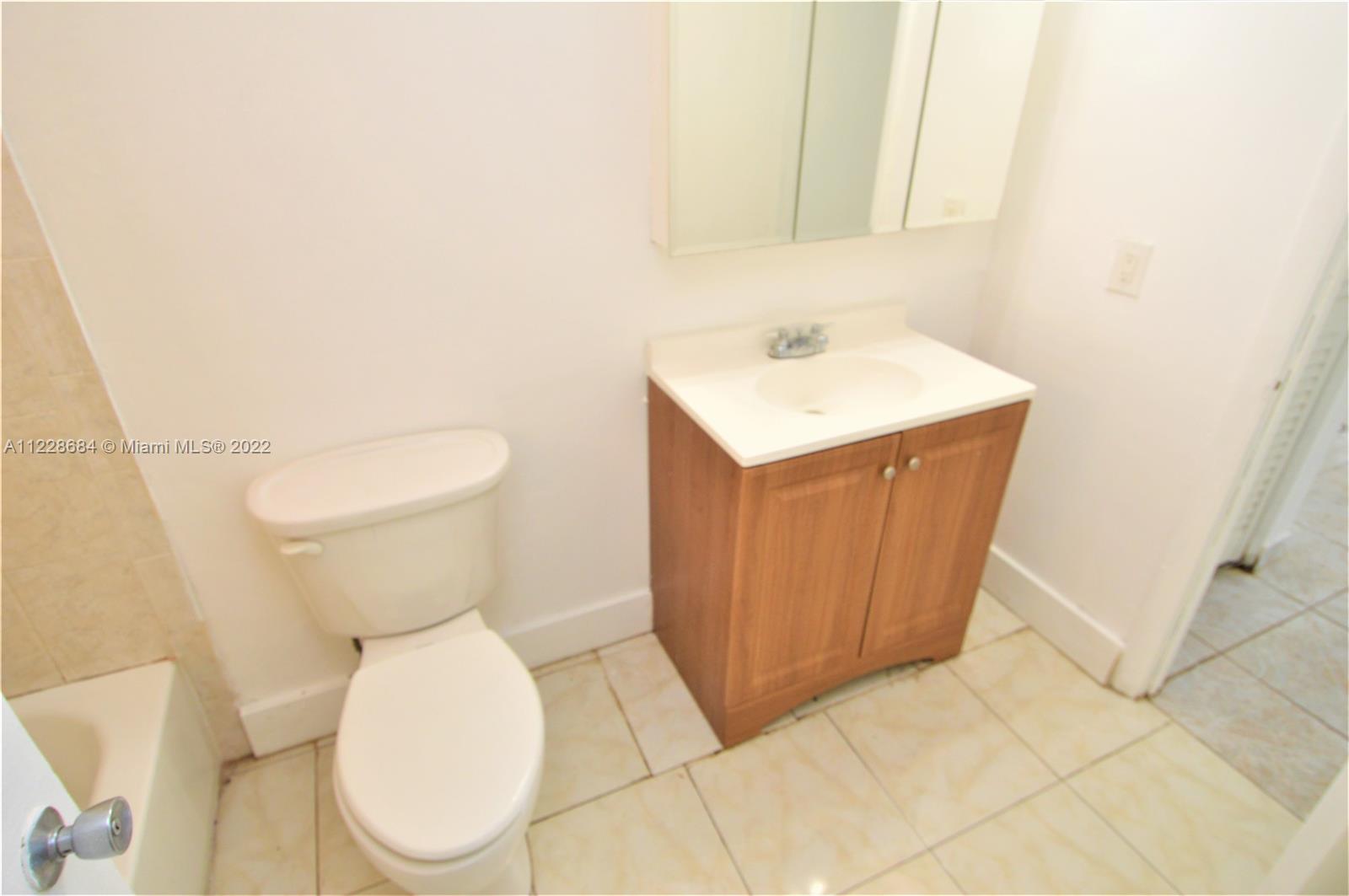 Golden Glades Miami, FL 33169 - Photo 8 of 17 a white toilet sitting next to a bathroom sink