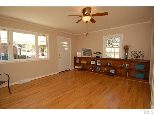 1919 Ruffin Street Durham, NC 27704 - Photo 9 of 25 Large Den or family room with gleaming new hardwood flooring plus a built in bookcase. It gets tons of light. Back door takes you to the rear patio and driveway on the Ruby St side. This is the primary entrance the owners tend to use. Den/Family/Great Room