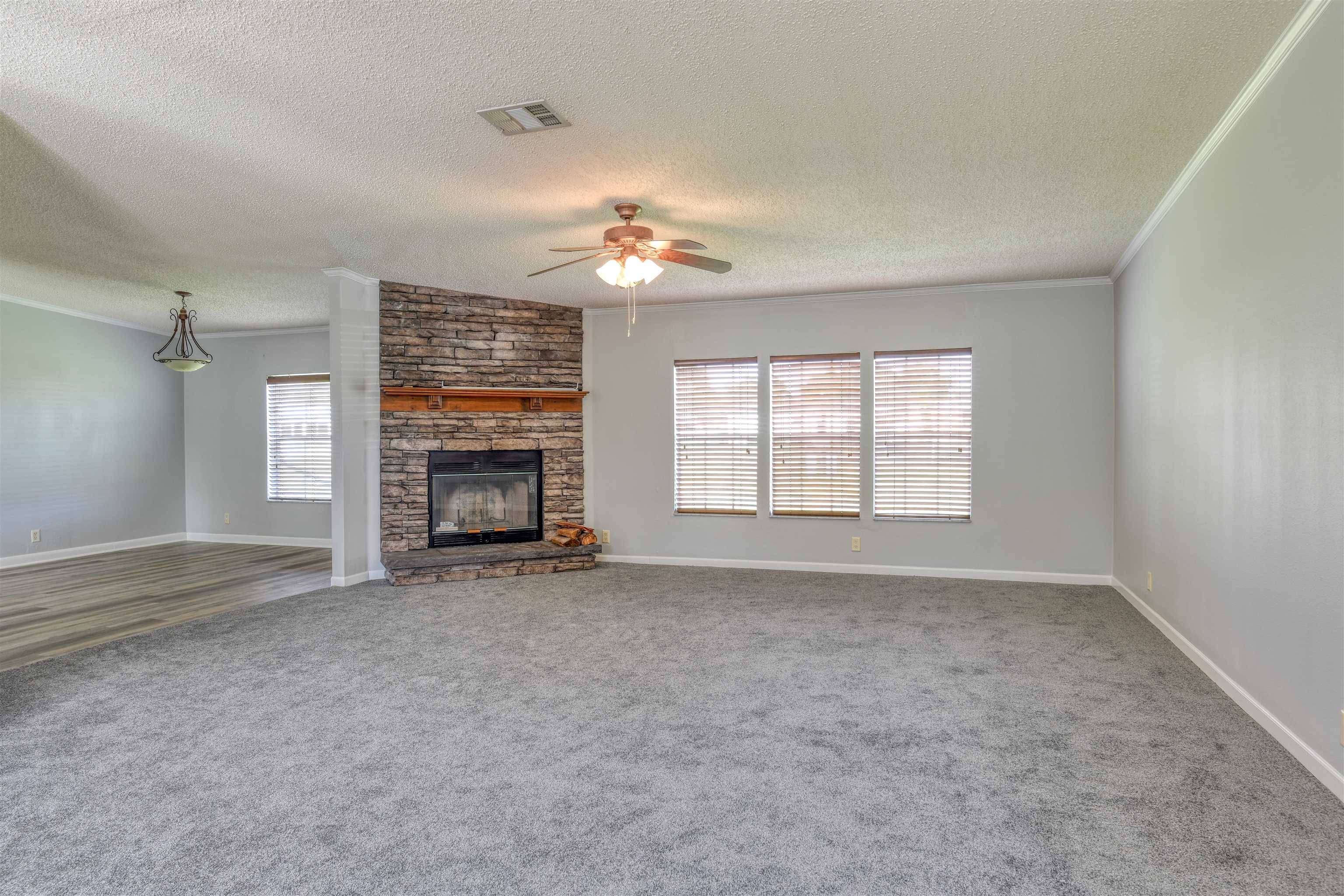3170 Usina Road St. Augustine, FL 32084 - Photo 3 of 33 wooden floor in an empty room with a fireplace