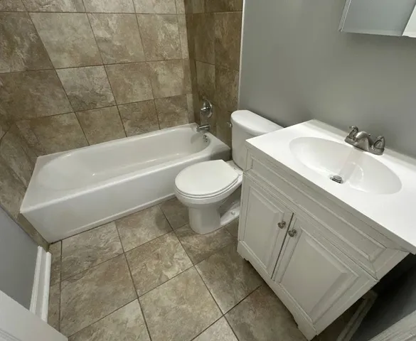 a bathroom with a sink a toilet and bathtub