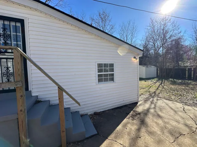 a view of a small space in the backyard of a house