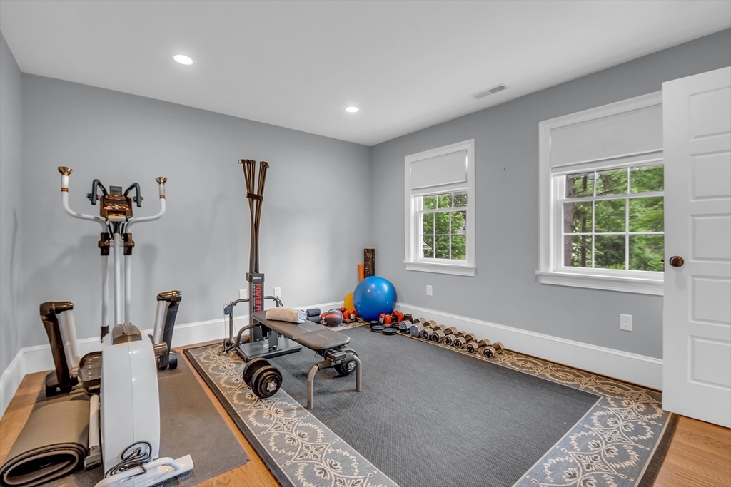 8 Holton Road Lexington, MA 02421 - Photo 30 of 42 a living room with furniture a window and gym equipment