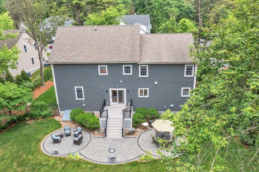 8 Holton Road Lexington, MA 02421 - Photo 40 of 42 a aerial view of a house with a yard patio and fire pit