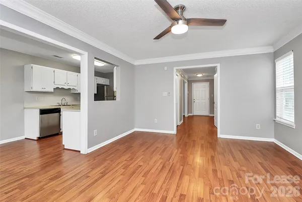 a view of a kitchen with wooden floor and a kitchen