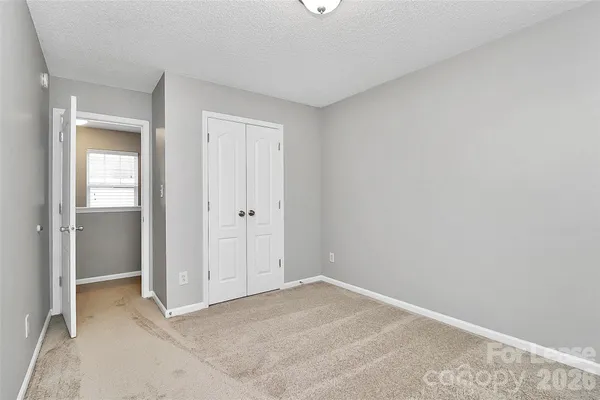 a view of an empty room and closet area
