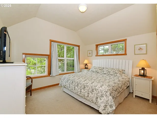 a bedroom with a large bed and a window