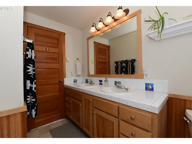 a bathroom with a sink vanity and mirror