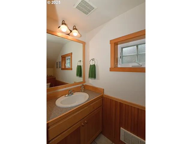 a bathroom with a sink a mirror and a toilet