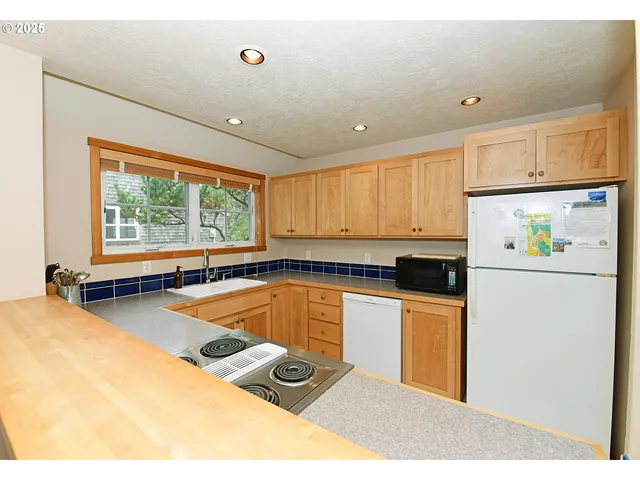 a kitchen with a sink appliances and cabinets