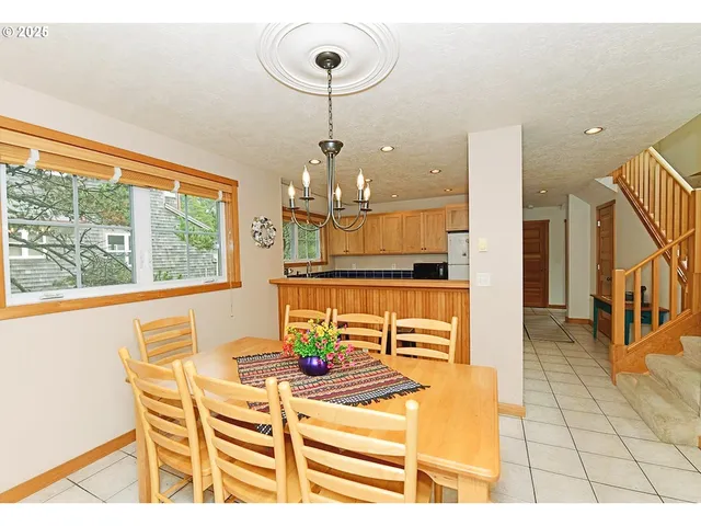 a view of a dining room with furniture a chandelier and wooden floor